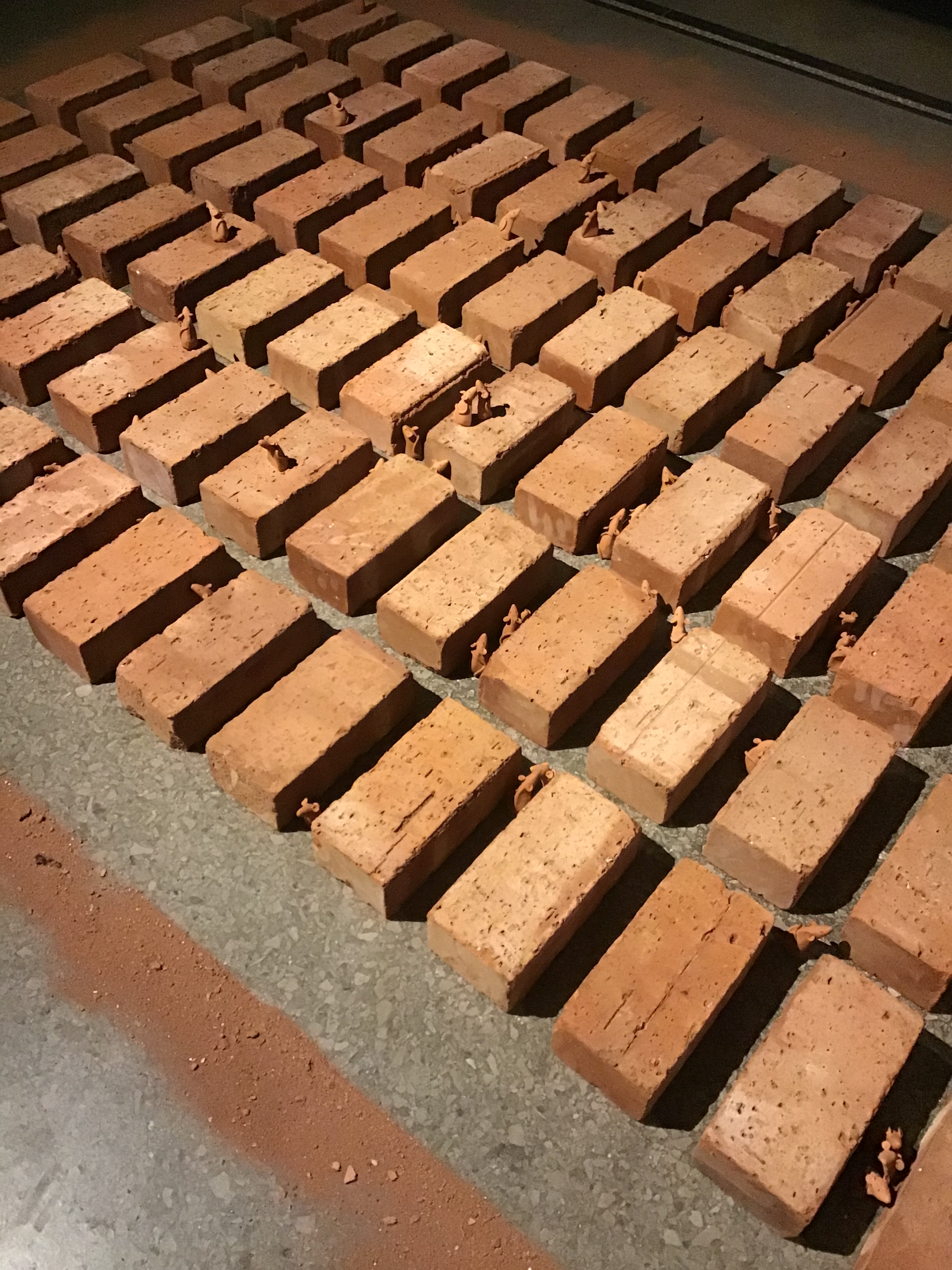 The Work is an installation made of clay bricks and mice
